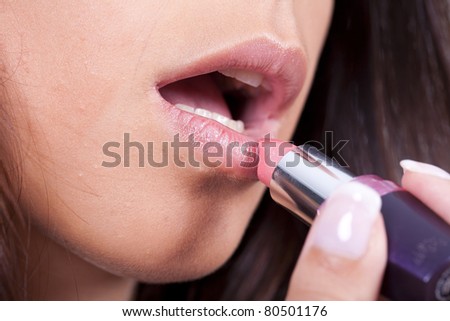 beauty woman applying lipstick on lips