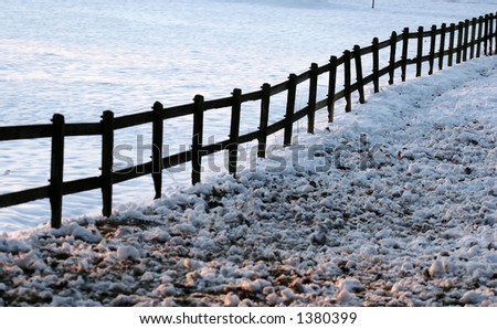 fence silhouette on a field in the winter
