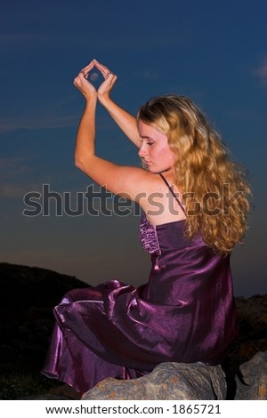 Dreamy girl holding the moon in her hands