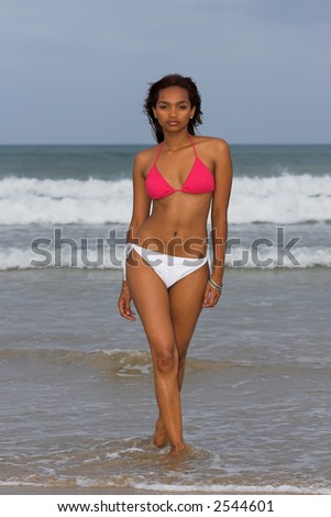 Ethnic Bikini model wearing pink and white bikini