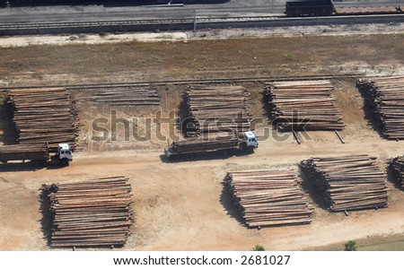 Aerial view of a Lumber Yard with trucks transporting the timber.