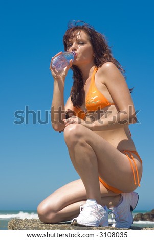 Fitness Model drinking water from a bottle