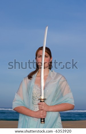 Attractive female model holding a samurai sword