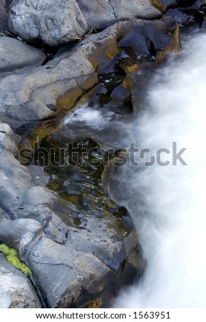 Water pounds this well worn rock as it works it\'s way downstream.