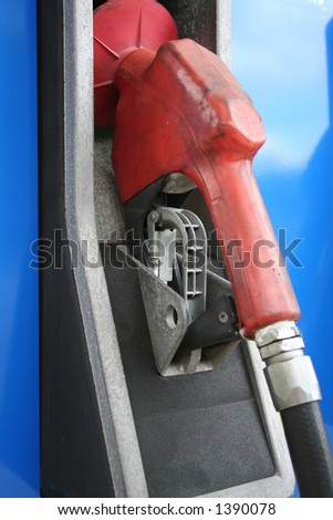 Red gas pump hanging in it\'s cradle