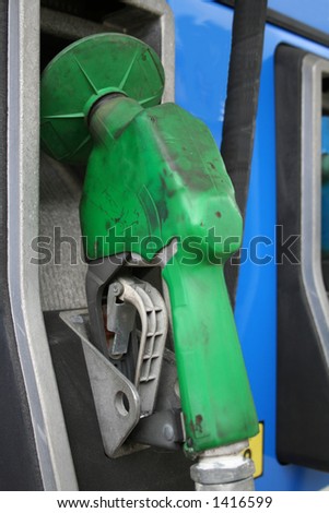 Green gas pump hanging in it\'s cradle