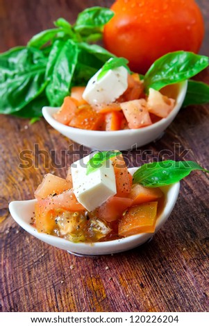 tomato and cheese salad on white bowl