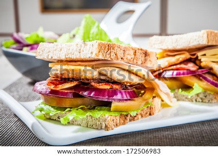 chicken breast sandwich with bacon ham and vegetables