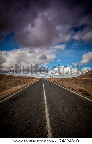 Long empty road running to the far horizon