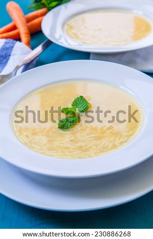 chicken soup served on white dish white spoon