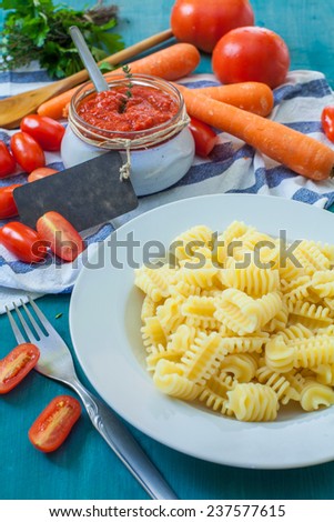 italian special pasta fisarmoniche with tomato sauce and herbs