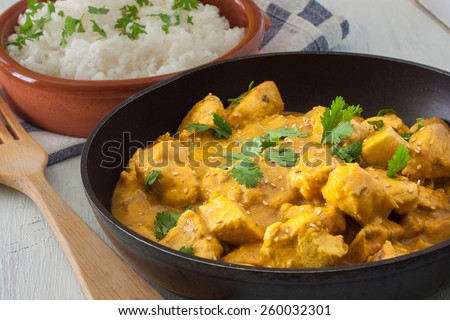 Butter chicken curry with basmati rice and cilantro.