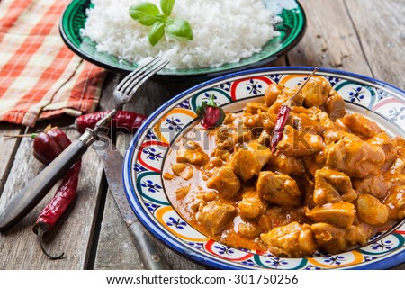 Chicken curry tikka masala with basmati rice on decorated bowl