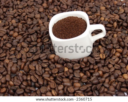 white coffe cup with black and brown beans