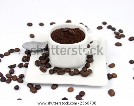 white coffe cup with black and brown beans on white background