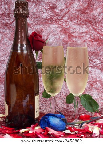 champagne bottle and two cups for celebrate san valentine`s day with a blue rose