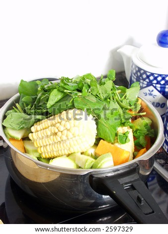 preparing a vegetables soup in the pressure cooker on the kitchen
