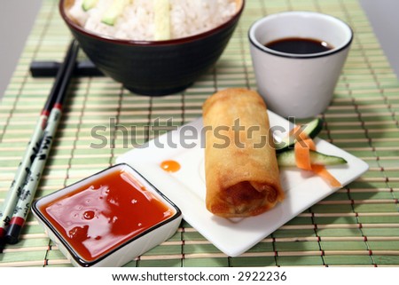 Crispy Chinese egg rolls with sweet and tangy chili sauce for dipping.