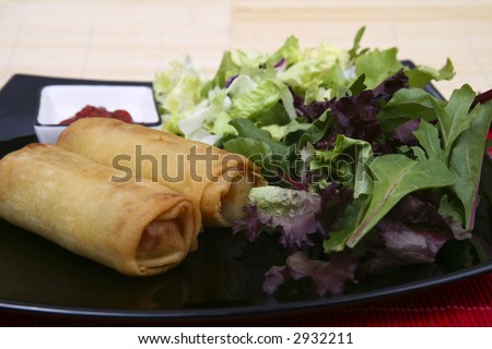 Crispy Chinese egg rolls with differents lettuce salad