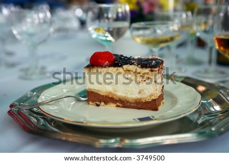 Dark chocolate mousse cake with cream and a strawberry