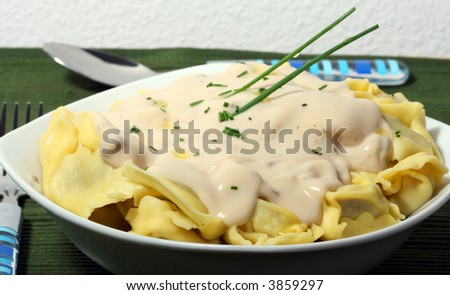 a plate of italian pasta with mushroom cream sauce