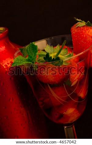 strawberry ice cocktail with cocktail shaker on black background