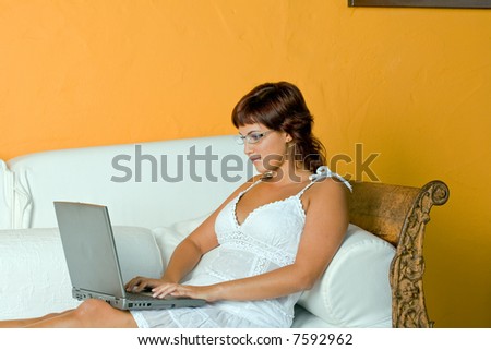 young woman work with laptop on a white chair