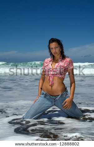 sexy young woman with jeans in the beach under blue sky