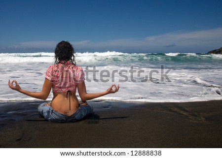 sexy young woman with jeans in the beach under blue sky on yoga position