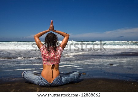 sexy young woman with jeans in the beach under blue sky on yoga position