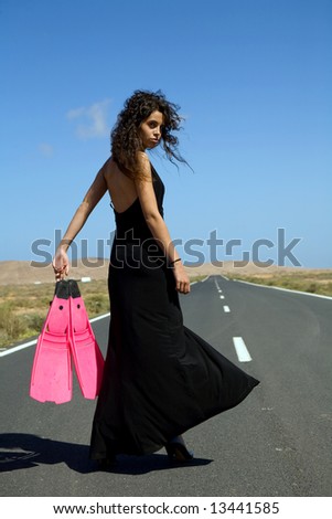young fashion model on a desert landscape under blue sky
