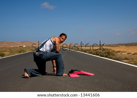young athletics man in the middle of a road
