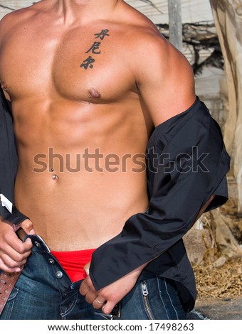 Muscular male torso with jeans and japanese tattoo