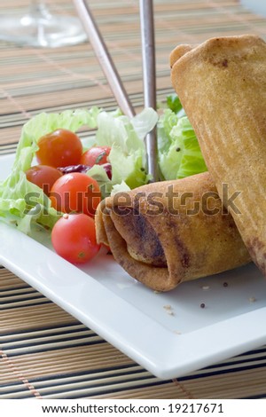 Crispy Chinese egg rolls with lettuce and tomato