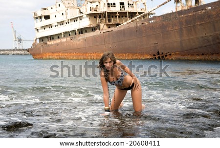 woman with fashion bikini near an abandoned ship