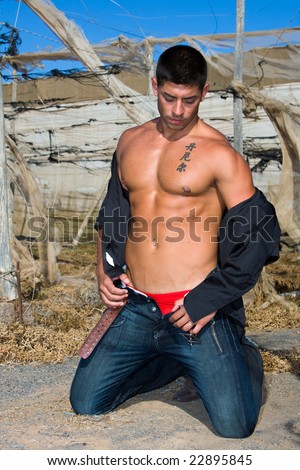 Muscular male with jeans and japanese tattoo