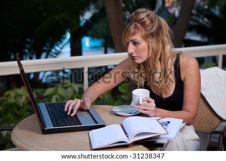 young attractive businesswoman working in a restaurant terrace