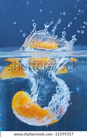 lemon and orange splashing on fresh water