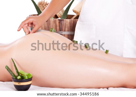 professional masseuse making a aloe treatment massage in the back