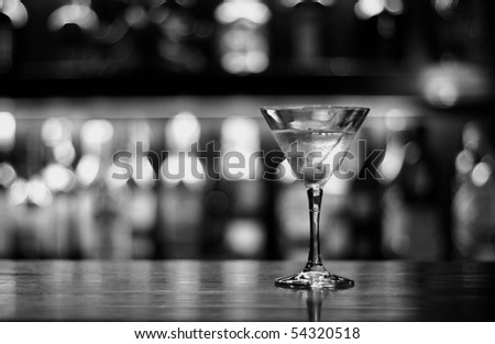 a cup of martini with olive on a old pub black and white conversion