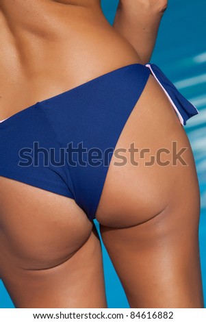 woman back with blue bikini on pool