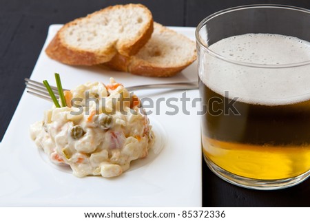 fresh potato salad with bread and a glass of beer