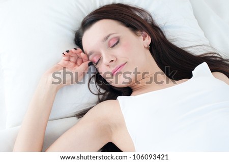 Good night: portrait of a beautiful caucasian woman sleeping on a pillow