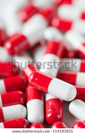 Vertical shot of red and white capsules, close-up