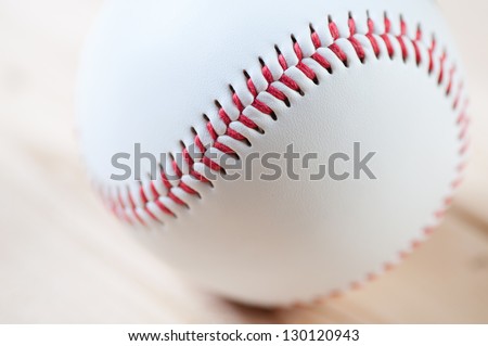 Close-up of a baseball ball on wooden boards, studio shot