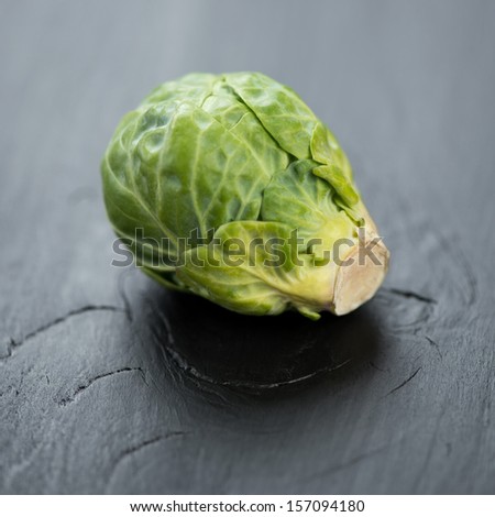 Brussels sprout on a black wooden background, close-up