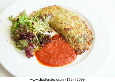 Vegetarian potato pie served with vegs and tomato sauce