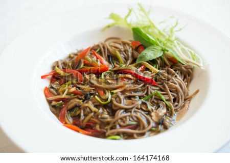 Close-up of buckwheat udon noodles with vegetable sauce