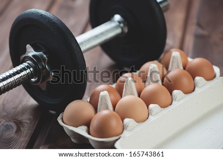 Building a muscle mass: weightlifting and protein food, horizontal shot - stock photo