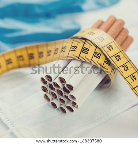 Bundle of cigarettes and a centimeter, close-up